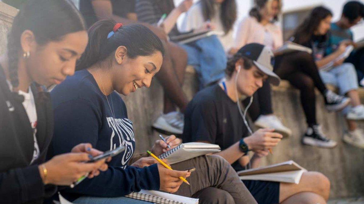 students taking notes in an outside class